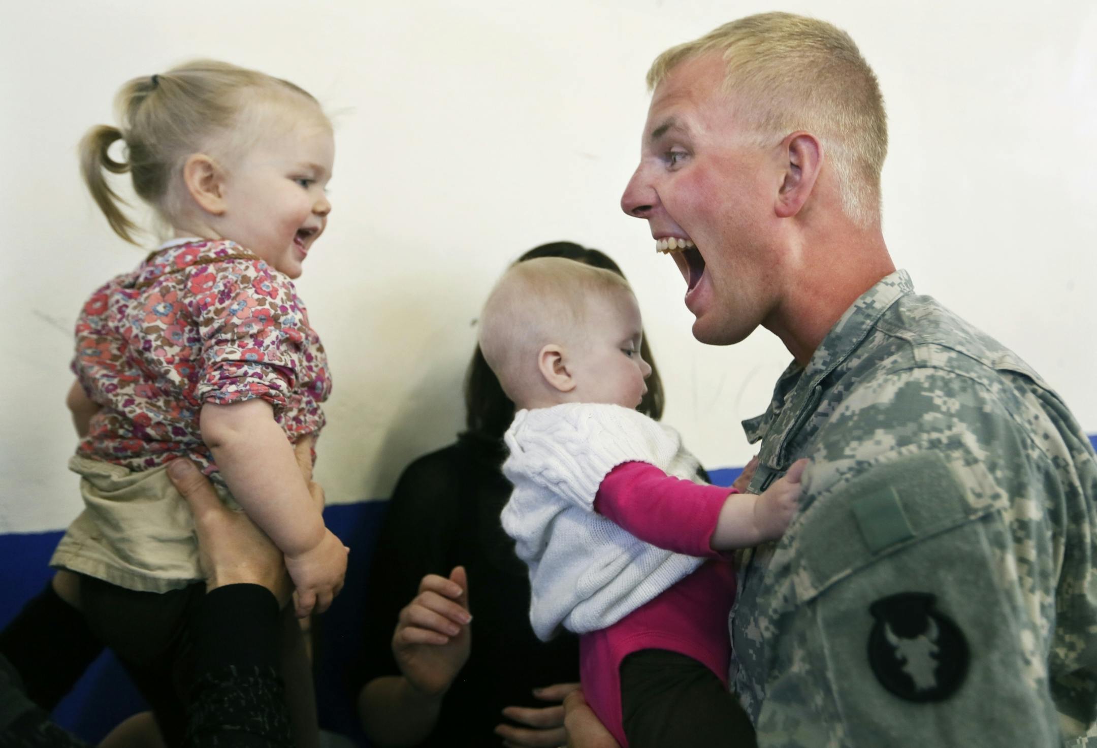 Soldiers from the 1st Brigade Combat Team, 34th Infantry Division of the National Guard recently returned from serving in Kuwait. Jayden Pholman,20 months and her sister Payton, six months, greeted their dad Staff Sgt. Alex Pohlman after he served a year in Kuwait.