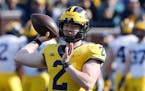 FILE- In this April 13, 2019, file photo, Michigan quarterback Shea Patterson throws during Michigan's annual spring NCAA college football game in Ann