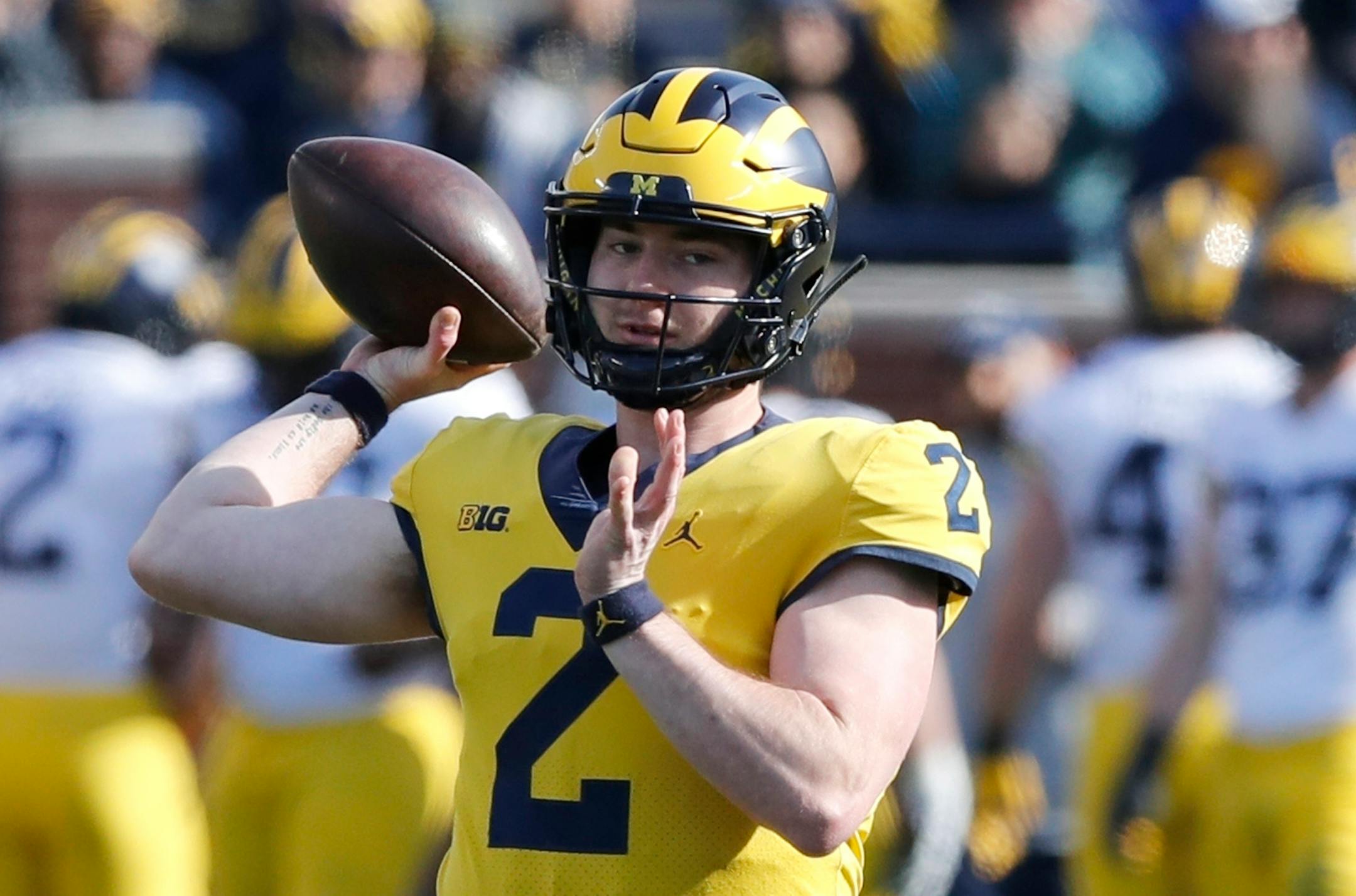FILE- In this April 13, 2019, file photo, Michigan quarterback Shea Patterson throws during Michigan's annual spring NCAA college football game in Ann Arbor, Mich. Patterson returns for a second season after transferring from Mississippi. The dual-threat standout will play behind four returning starters in a new-look offense featuring a trio of talented receivers. (AP Photo/Carlos Osorio)