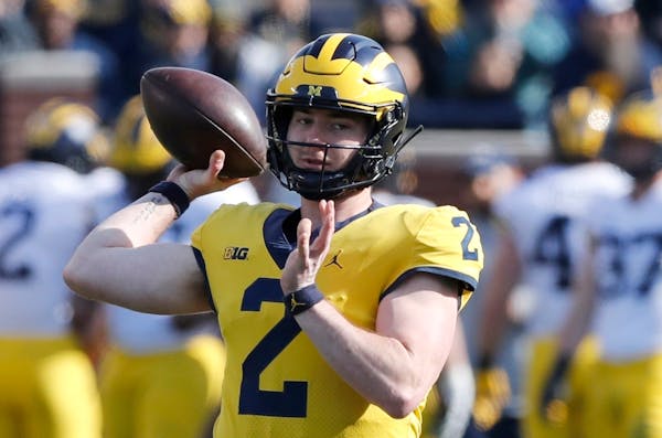 FILE- In this April 13, 2019, file photo, Michigan quarterback Shea Patterson throws during Michigan's annual spring NCAA college football game in Ann