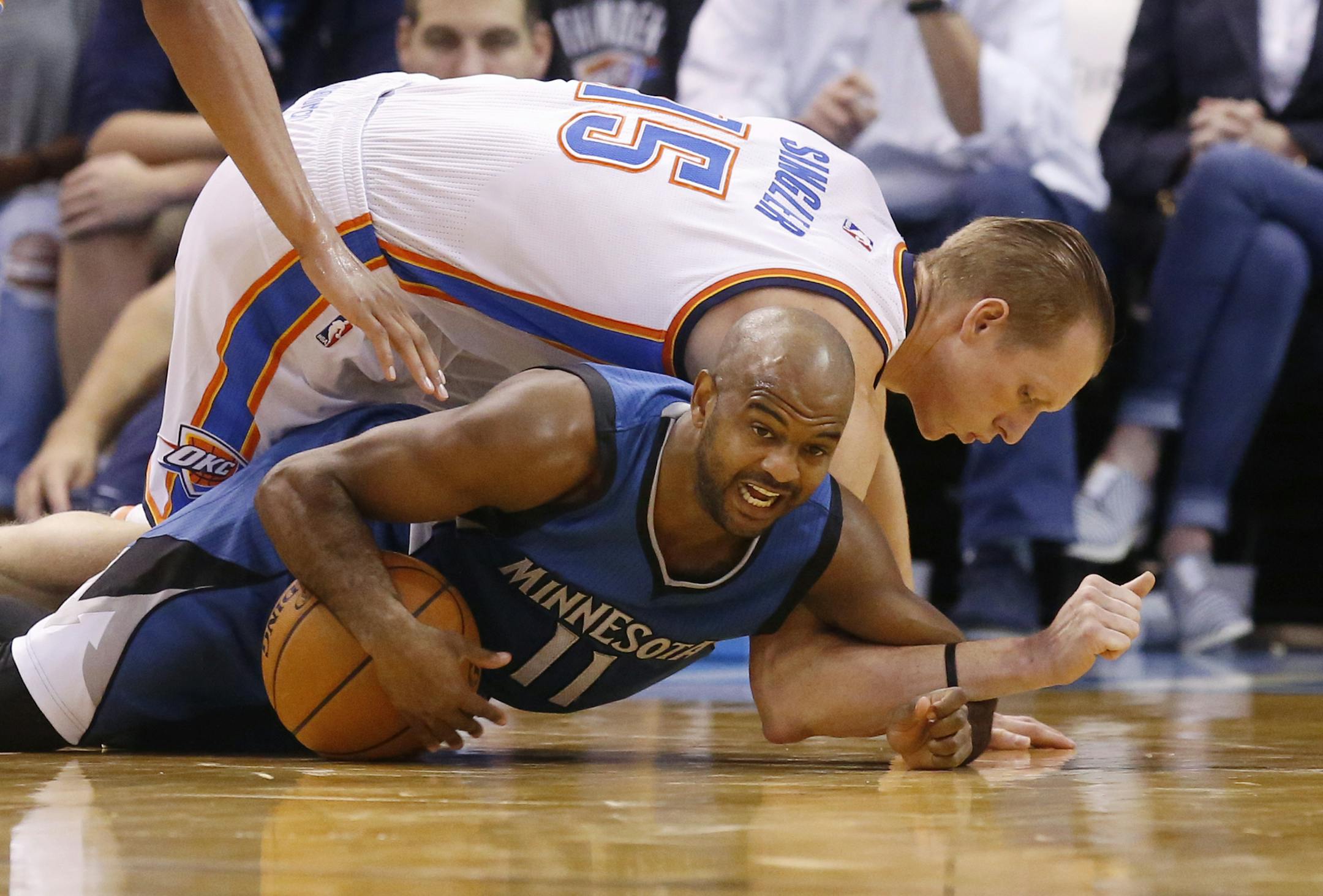 Minnesota Timberwolves guard John Lucas III (11) dives for the ball in front of Oklahoma City Thunder forward Kyle Singler (15) in the third quarter of an NBA basketball preseason game in Oklahoma City, Sunday, Oct. 16, 2016. Oklahoma City won 112- 94. (AP Photo/Sue Ogrocki)