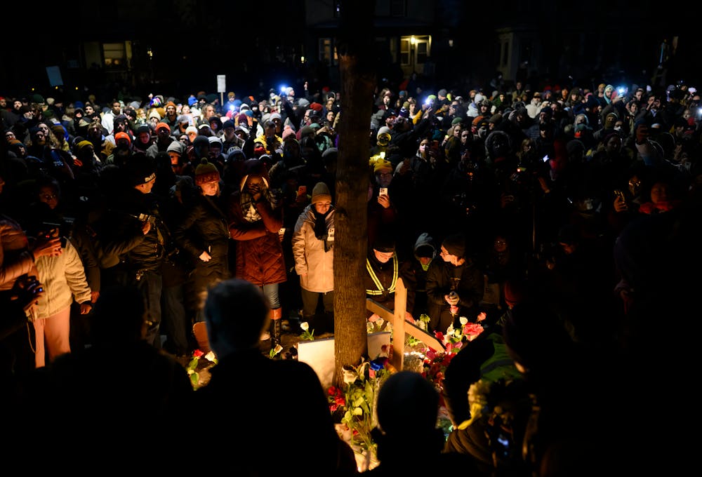 A few thousand people gather around a memorial for Renee Nicole Good, 37, who was shot and killed by federal law enforcement earlier in the day at Portland Avenue at East 34th Street in Minneapolis on Wednesday, Jan. 7.