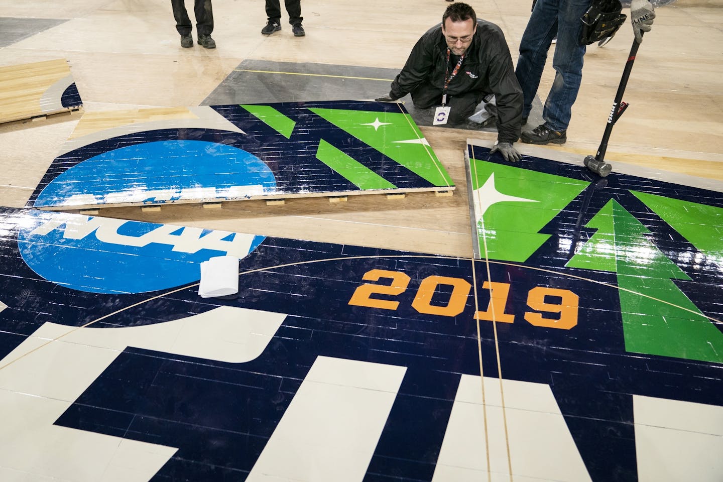 SMG operations worker Michael Stauffacher helped install the official 2019 NCAA Final Four basketball court Friday at U.S. Bank Stadium.