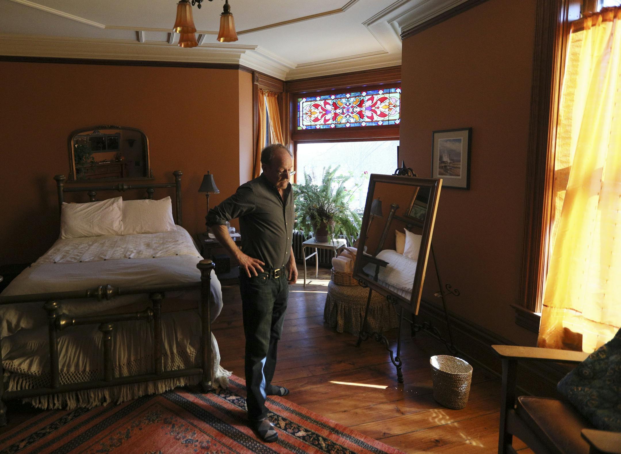 Scott Kramer is photographed in one of the bedrooms in Stt. Paul's historic Dearing Mansion.