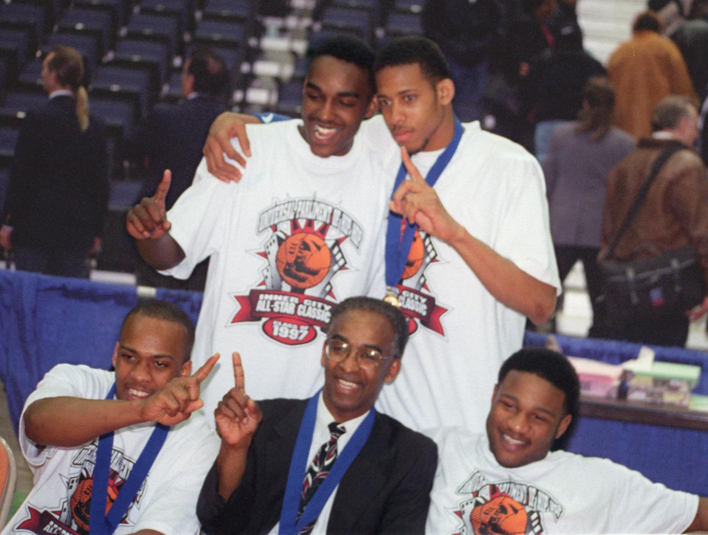 -- At Civic Center courtside following thier winning final game Saturday night, are (l. to r.-top) Jabbar Washington, Kevin Holley, (l. to r.-bottom) Ozzie Lockhart, Coach Robin Ingram, and Khalid El-Amin.