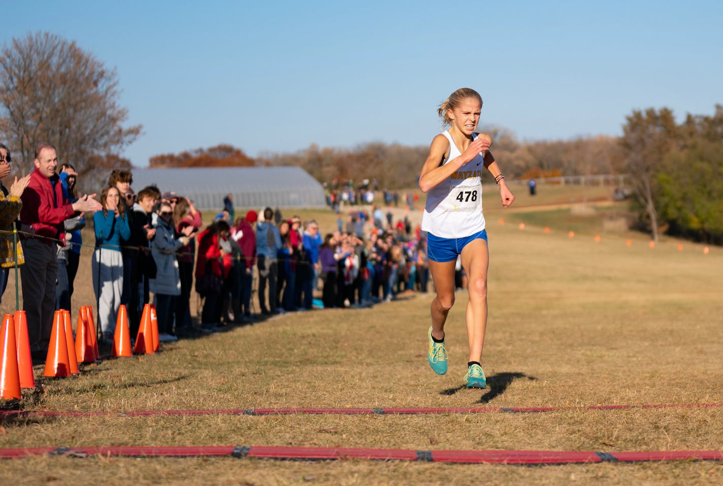 Wayzata's Abbey Nechanicky crosses the finish line of the MSHSL Section 6AAA Girl's Cross Country Championships Wednesday, Oct. 26, 2022 at Gale Woods Farm in Minnetrista, Minn. Nechanicky set a personal record and course record of 16:43.70. ]