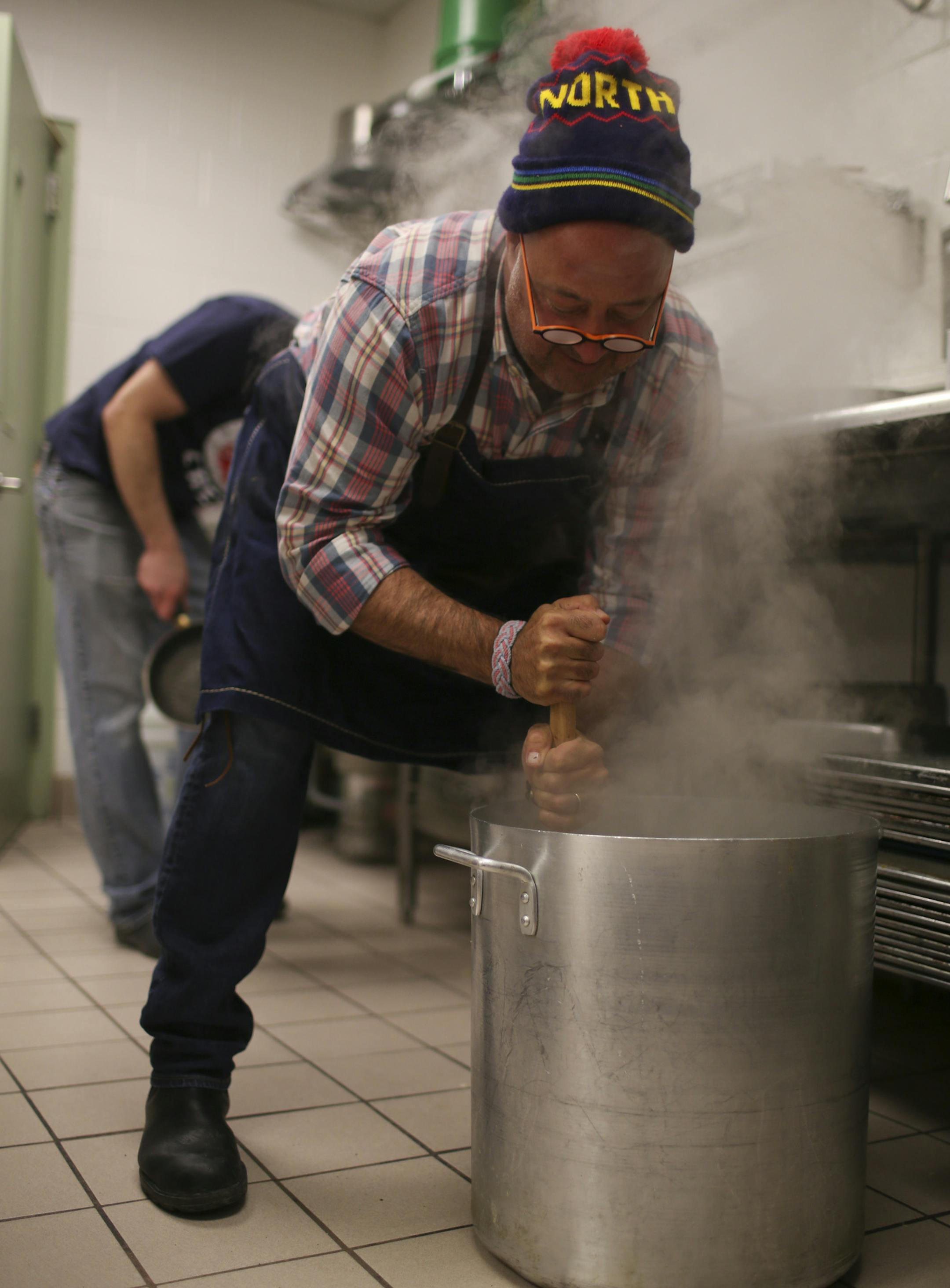 Travel Channel host (and Twin Cities resident) Andrew Zimmern stopped by the Salvation Army's Payne Ave. location in St. Paul to cook with chef Jeff Ansorge, former head chef at the Captal Grille in Minneapolis, as he prepared a meal Monday afternoon, March 3, 2014 for donors and volunteers. Andrew Zimmern dug in to mash a big batch of potatoes while working in the kitchen at the Eastside Corps. Community Center in St. Paul Monday afternoon. ] JEFF WHEELER ‚Ä¢ jeff.wheeler@start