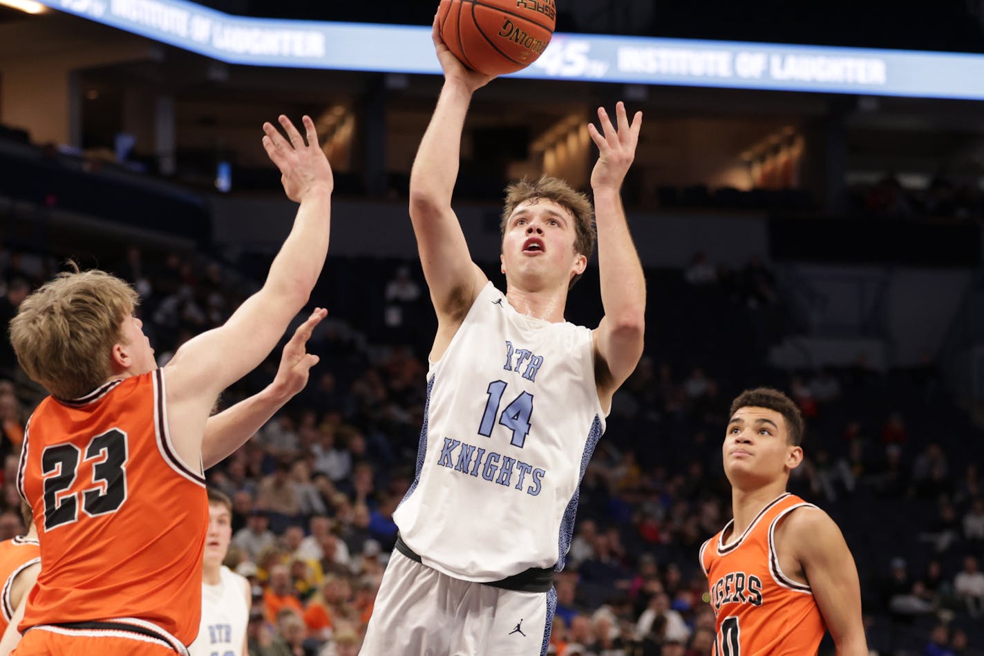 Russell-Tyler-Ruthton's Aiden Wichmann (14) lays the ball up in the first half. Wichman's game-high 23 points leads his team in tomorrow's championship game. Photo by Cheryl A. Myers, SportsEngine