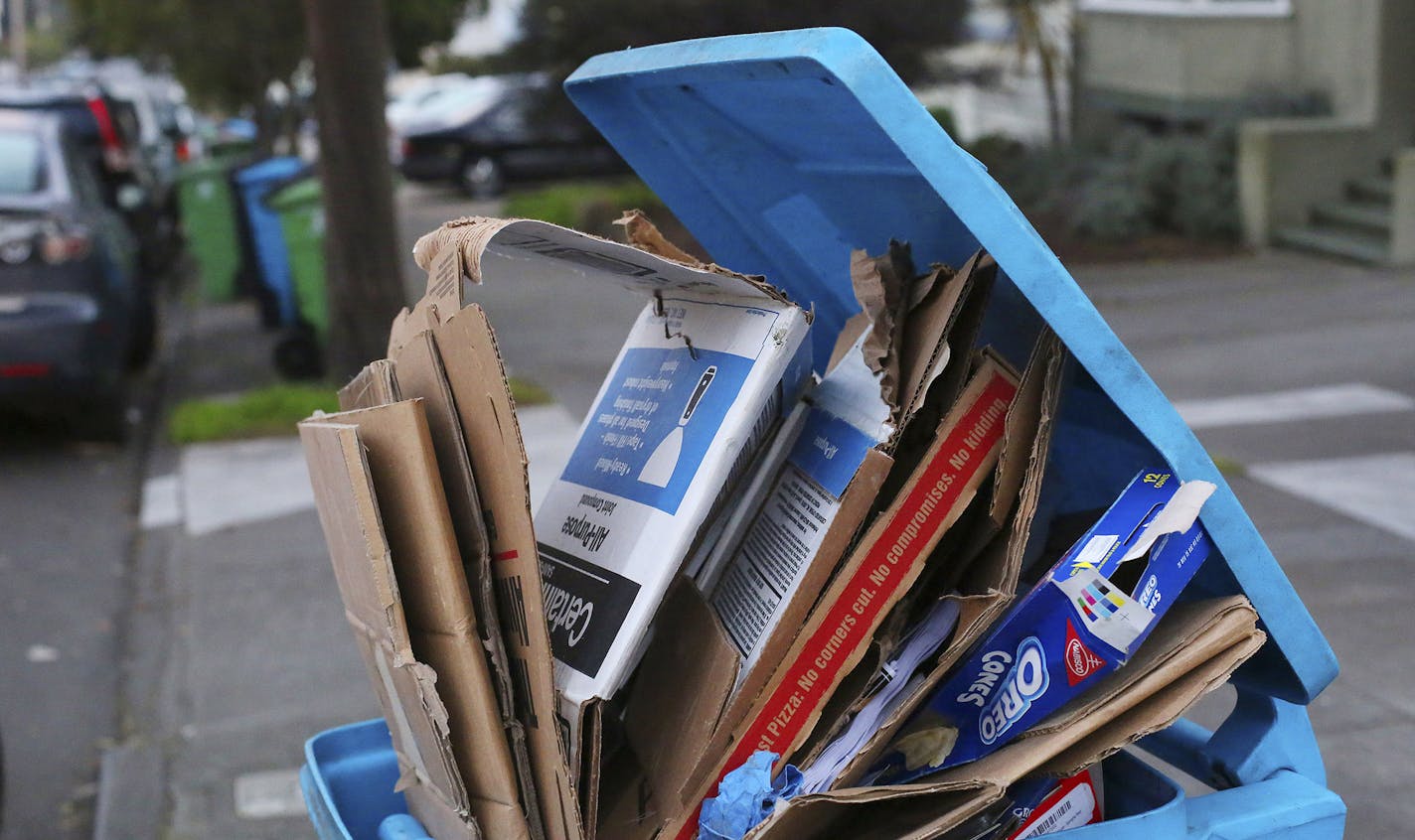 Cardboard overflows from a recycling bin in San Francisco, Jan. 28, 2016. Delivery services now come through in hours, not days. But the boxes after boxes generated are creating environmental concerns, and some guilt. (Jim Wilson/The New York TImes) ORG XMIT: MIN2016042812294708