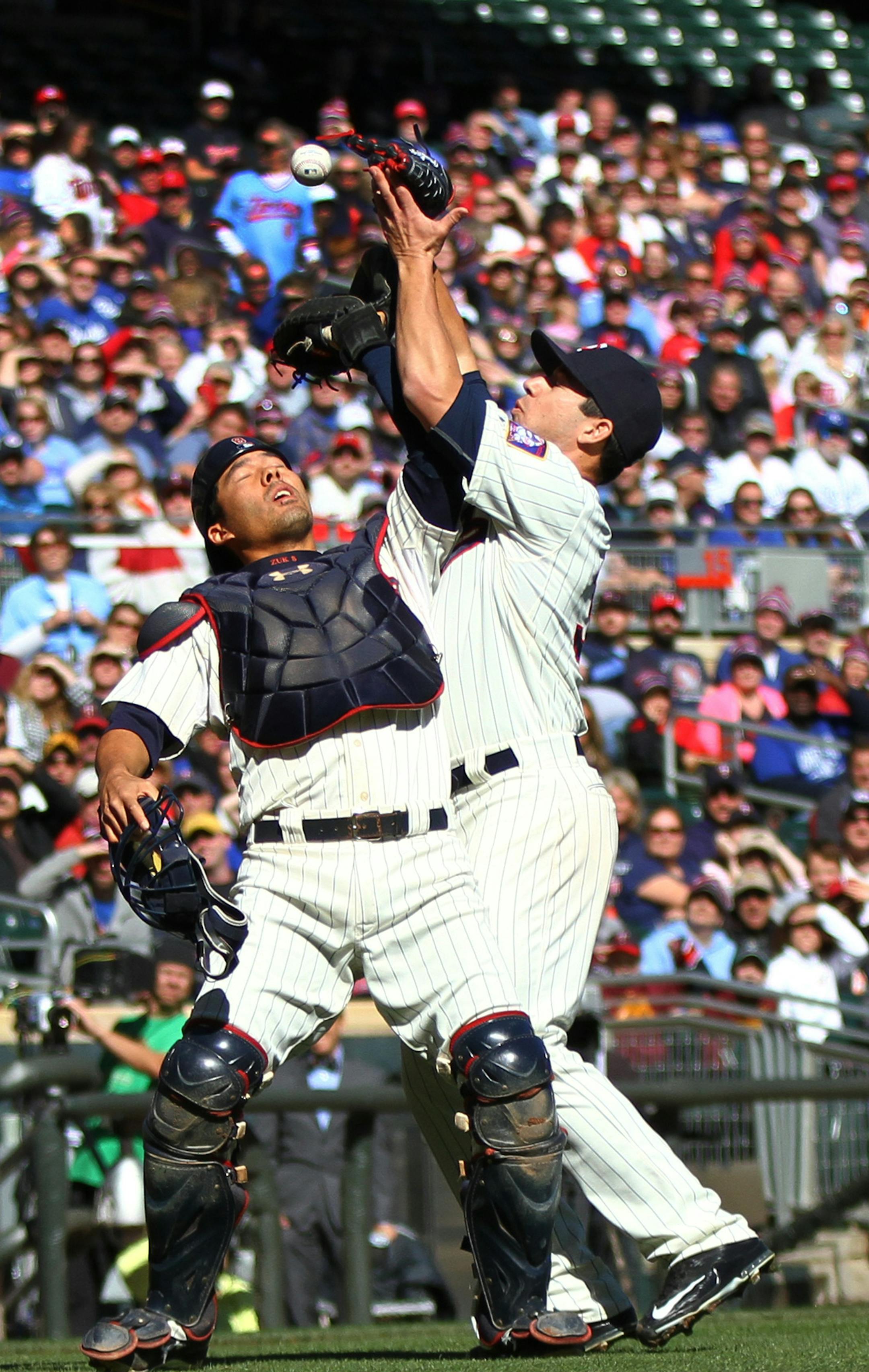 Twins&#xed; catcher Kurt Suzuki and pitcher Tommy Milone collide while trying to catch a pop up hit by Kansas City Royals' Salvador Perez in the second inning. Suzuki was given an error on the play. ] SHARI L. GROSS &#xef; sgross@startribune.com / Minneapolis, MN / October 3, 2015 / The Minnesota twins played the Kansas City Royals at Target Field Saturday afternoon.