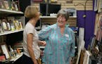 Valeta Cornwell worked with a customer at picking out a piece of art at New Uses, a home furnishings resale shop, Friday, July 2, 2015 in Woodbury, MN