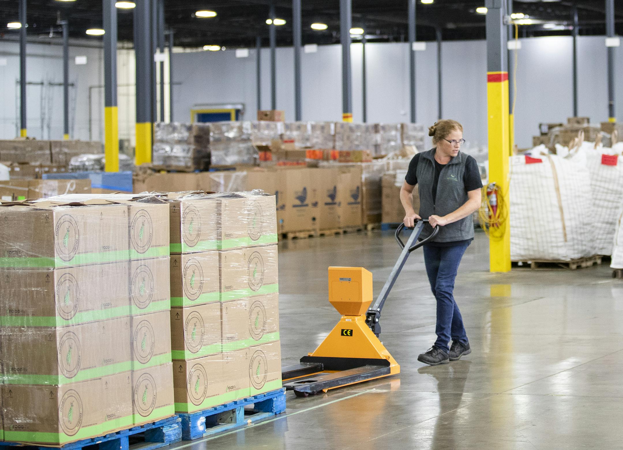 Karen Javurek, a volunteers experience ambassador with Second Harvest Heartland, moves pallets of boxed food for the FOODRx program. FOODRx aims to connect food prescriptions and basic need services to low income patients through the MN health care system. Volunteers pack food at the new warehouse location for Second Harvest Heartland on Friday, Sept. 7, 2018. Second Harvest Heartland received $18 million in bonding to open a larger warehouse in Brooklyn Park with more refrigeration for fresh fo