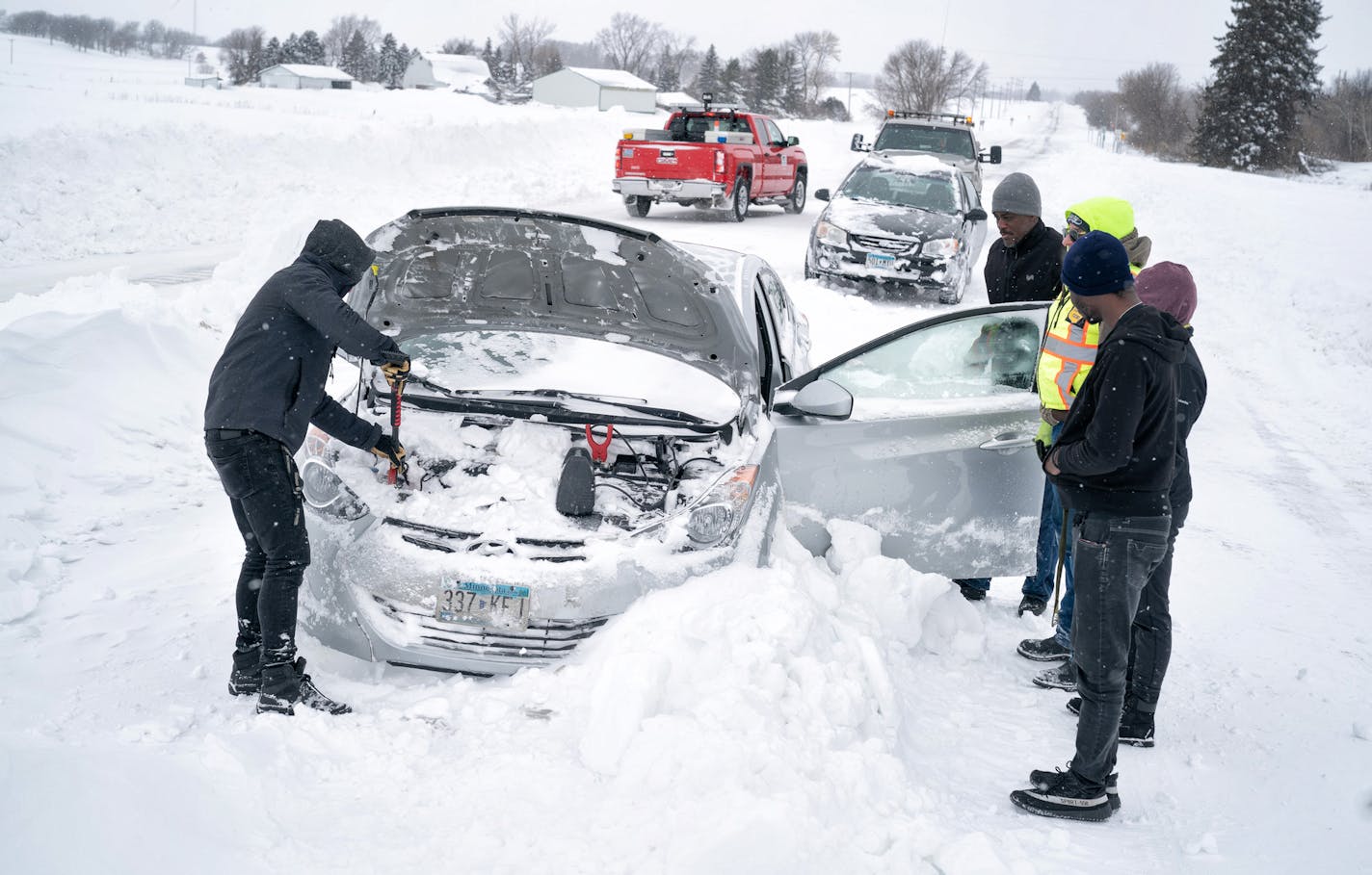 Isaac Baker first restarted his girlfriends car in the background and then came to help Modeste Zinzindo with his vehicle which had stalled on Hwy 218 yesterday. The engine compartment had filled with snow from the ferocious blizzard winds. ] GLEN STUBBE • glen.stubbe@startribune.com Monday, February 25, 2019 Follow on the blizzard that stranded hundreds of motorists in southern Minnesota.