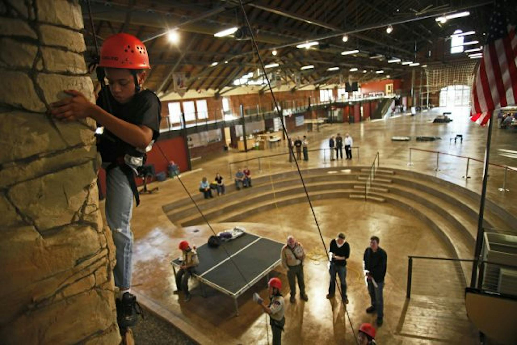 The Boy Scouts' new Base Camp, which aims to attract urban youth to scouting, is in a 27,000-square-foot building once used as a cavalry hall at Fort Snelling. It contains, among other things, a climbing wall and a space shuttle simulator. Above, Jahbri Jones, 13, of Woodbury, took on the climbing wall.