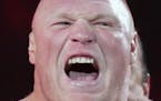 FILE - In this March 29, 2015, file photo, Brock Lesnar makes his entrance at Wrestlemania XXXI in Santa Clara, Calif. UFC 200 has grown so big that a