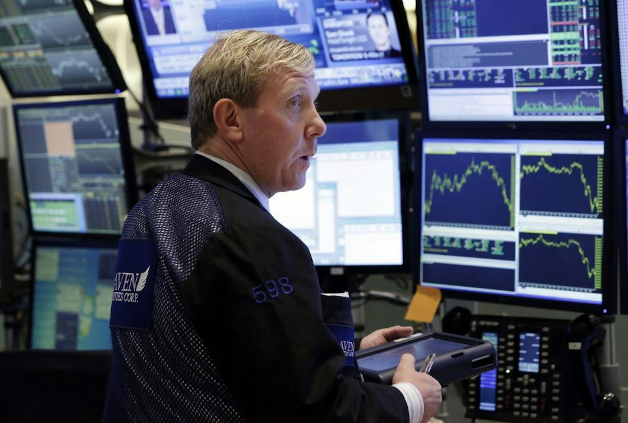 Trader Richard Cohen works in a booth on the floor of the New York Stock Exchange Monday, June 17, 2013. Stocks were up Monday because investors think Fed leaders will determine that the economy isn't recovering fast enough.