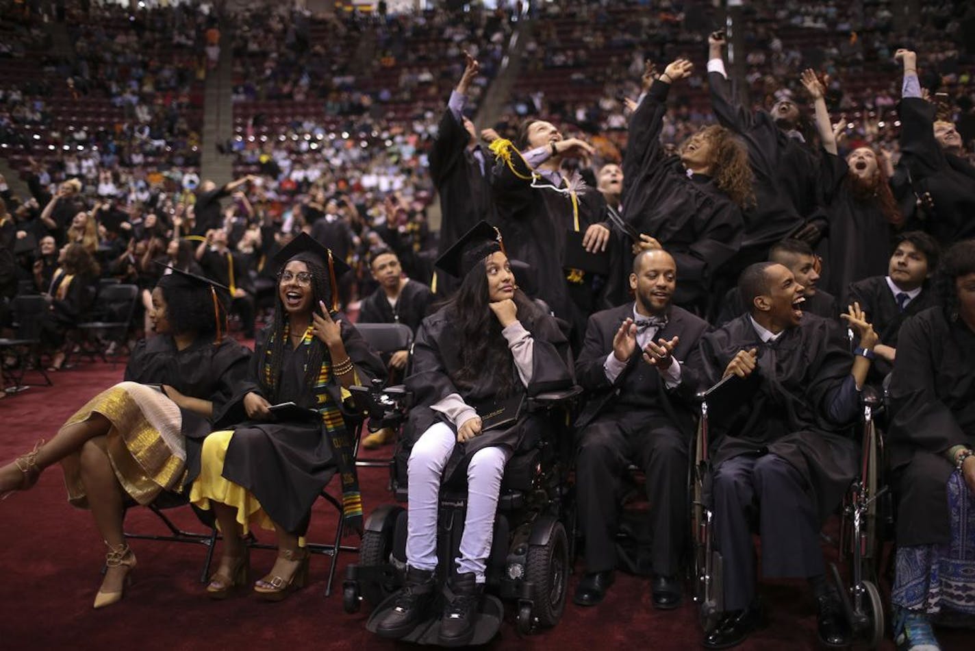 A group of Minneapolis South High School classmates tossed their mortarboards into the air at the end of their graduation ceremony at Mariucci Arena.