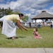 Ashley Goodsky of Nett Lake encouraged her 10-month-old daughter Aleena to walk during a ceremony commemorating the restoration of more than 28,000 ac
