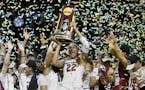 South Carolina forward A'ja Wilson (22) holds the trophy as she and her teammates celebrate a win over Mississippi State in the final of NCAA women's 