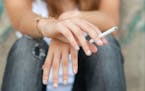 iStockphoto.com
Teenage hands holding cigarette outdoor.