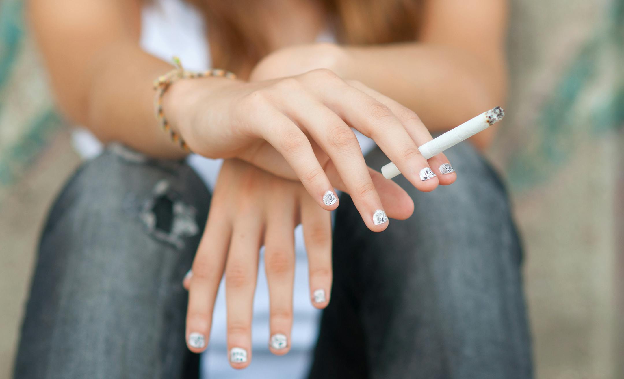iStockphoto.com
Teenage hands holding cigarette outdoor.
