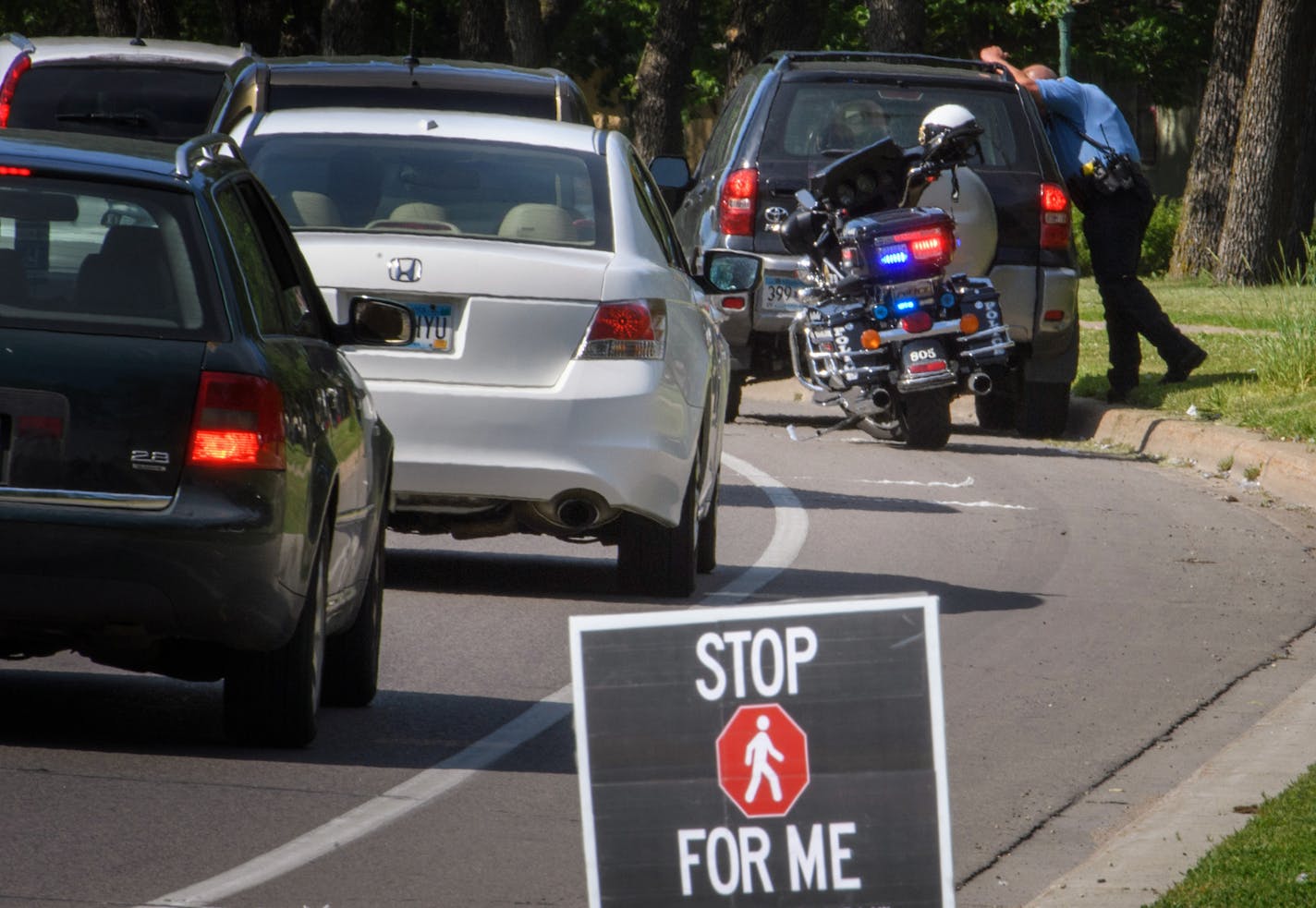 A St. Paul police officer pulled over a blue Toyota for driving through a marked crosswalk with pedestrians in it on Wednesday.