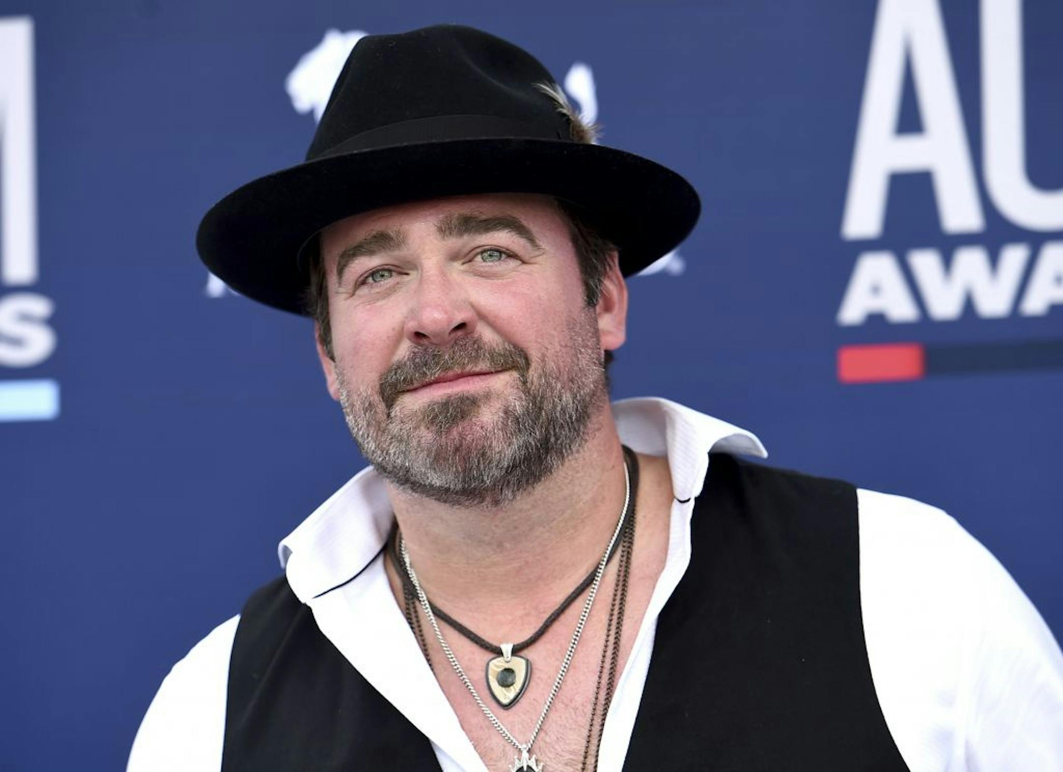 In this Sunday, April 7, 2019, photo, Lee Brice arrives at the 54th annual Academy of Country Music Awards at the MGM Grand Garden Arena in Las Vegas. Country singer Lee Brice tested positive for COVID-19 and will not perform as scheduled at the CMA Awards on Wednesday, Nov. 11, 2020.