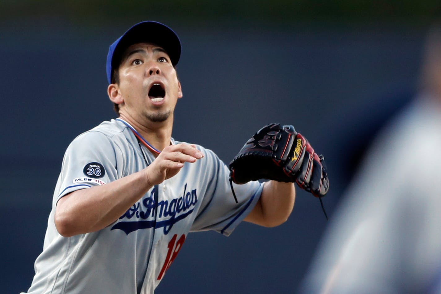 Los Angeles Dodgers' Kenta Maeda looks up as a ball from San Diego Padres' Josh Naylor goes over his head before being fielded by shortstop Corey Seager for the out at first during the first inning of a baseball game Wednesday, Aug. 28, 2019, in San Diego. (AP Photo/Gregory Bull) ORG XMIT: CAGB104