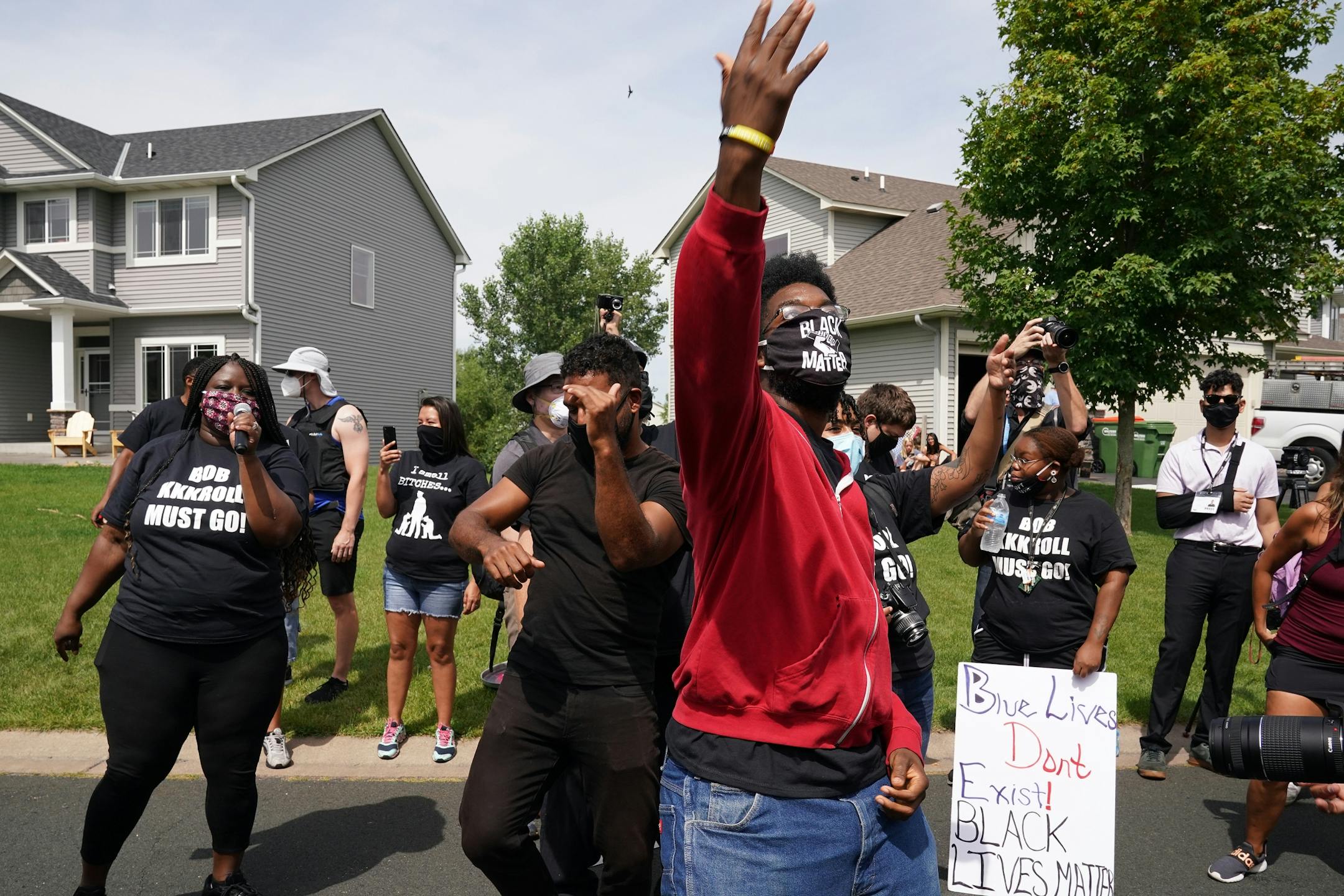 Toussaint Morrison, left, and DJ Hooker, right, danced in the street as he and more than 100 Black Lives Matter protesters rallied outside the home of Minneapolis Police Federation president Bob Kroll this summer.