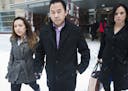 Koua Fong Lee, center, walked with his wife Panghoua Moua after a verdict in the Toyota liability outside the Federal Courthouse in downtown Minneapol