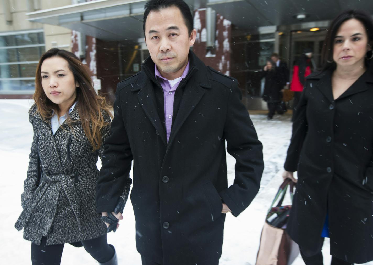 Koua Fong Lee, center, walked with his wife Panghoua Moua after a verdict in the Toyota liability outside the Federal Courthouse in downtown Minneapolis, Tuesday, Feb. 3, 2015.