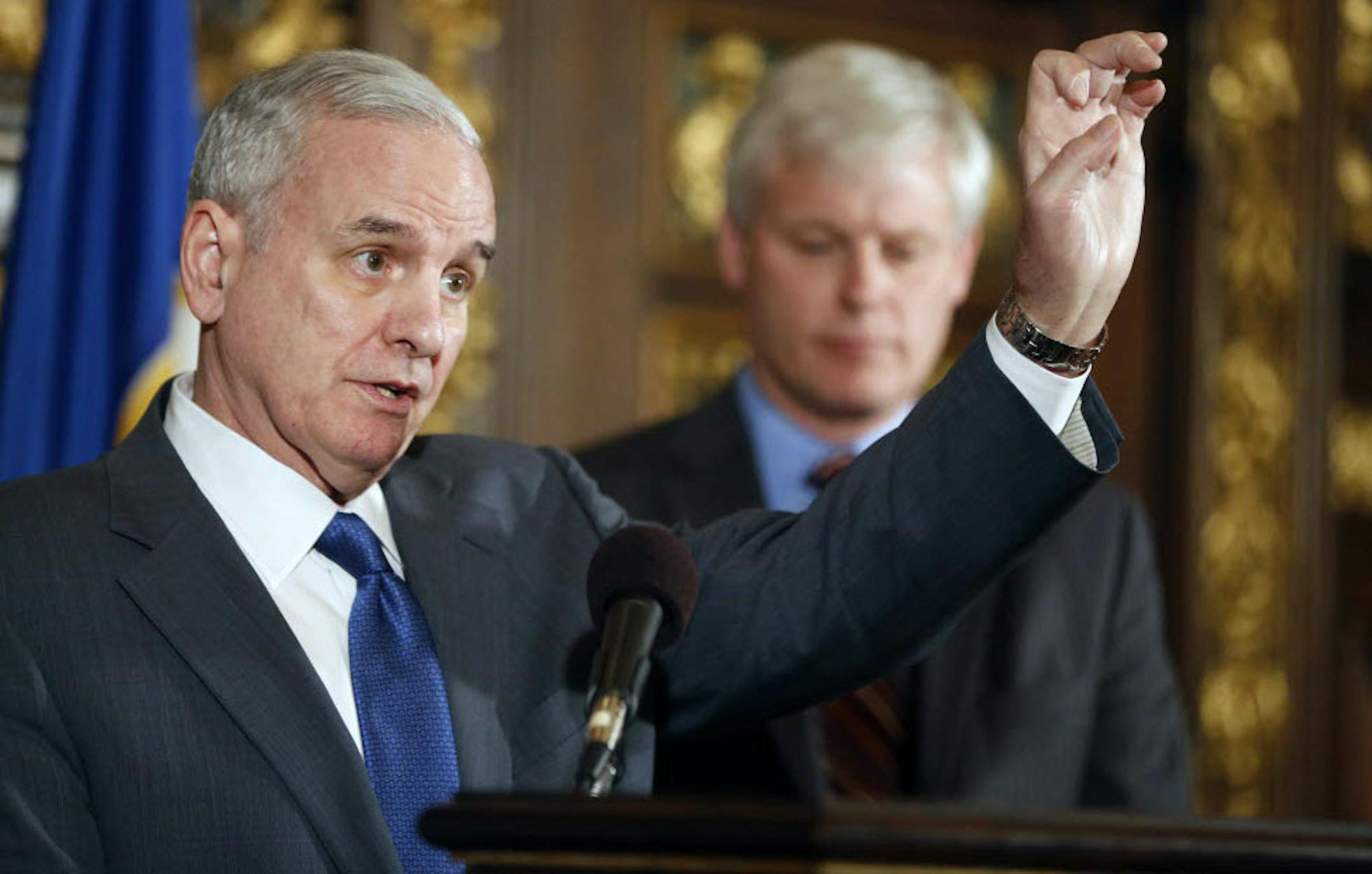 Gov. Mark Dayton and legislative leaders on Sunday announced a budget deal that would raise about $2 billion in new revenue, but includes $400 million in property tax breaks. Behind him is House of Representatives majority leader Paul Thiessen.