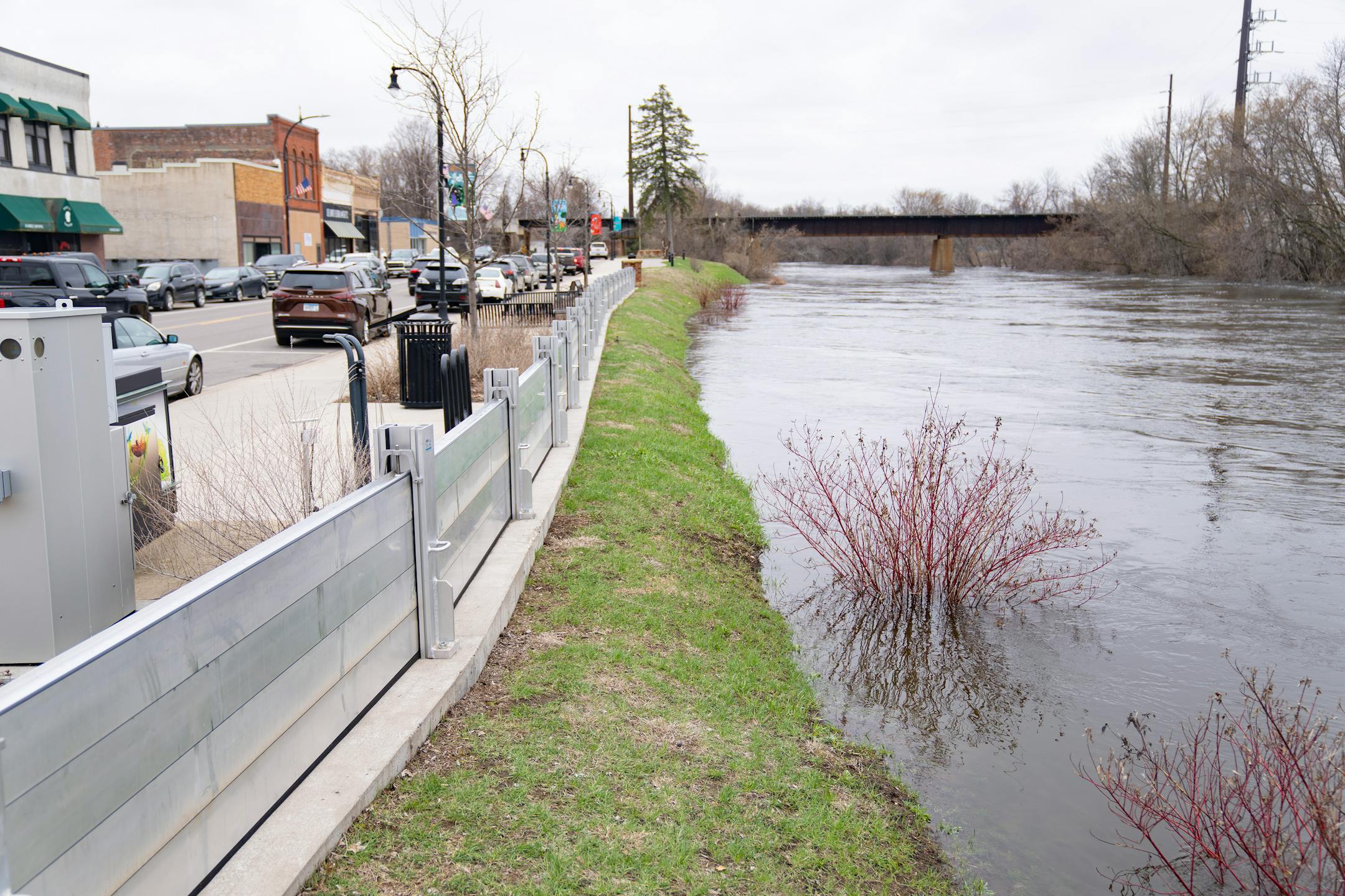 A flood wall stands on the bank of the Crow River as waters rise near Bridge Ave E. Wednesday, April 19, 2023, in Delano, Minn.