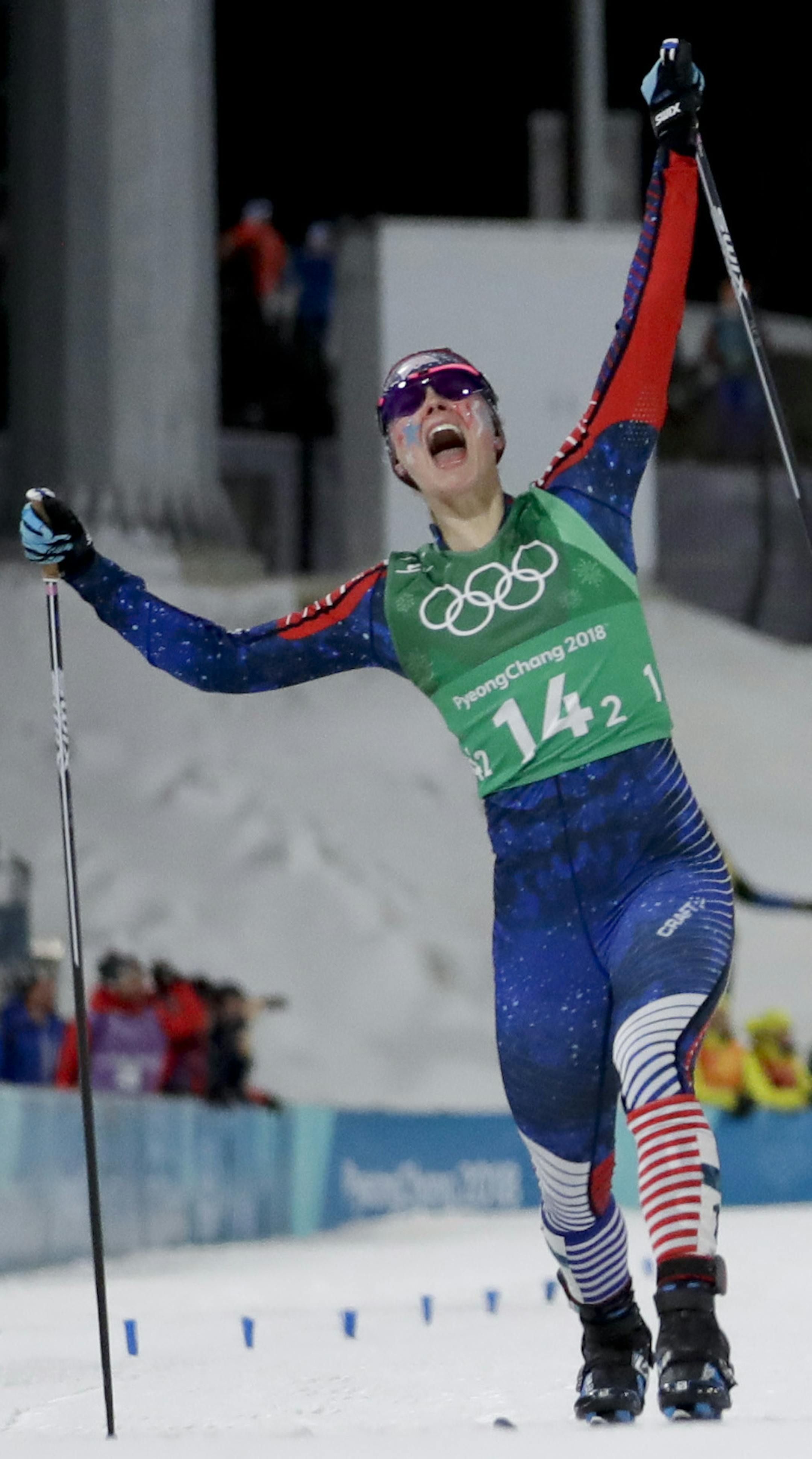 Jessica Diggins, left, of the United States, celebrates after winning the gold medal past Stina Nilsson, of Sweden, in the during women's team sprint freestyle cross-country skiing final at the 2018 Winter Olympics in Pyeongchang, South Korea, Wednesday, Feb. 21, 2018. (AP Photo/Matthias Schrader)