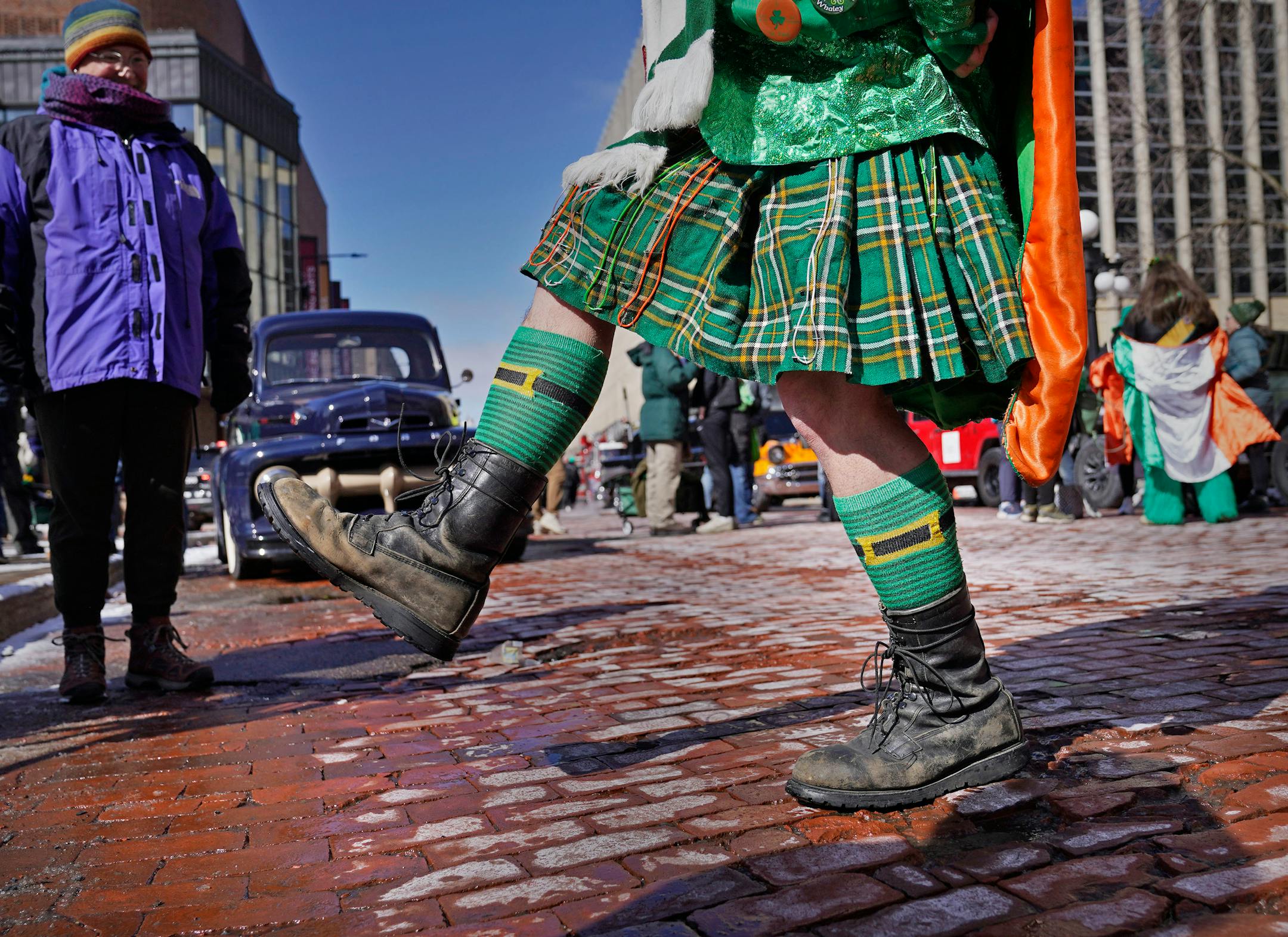 Jeff Schmidt of Woodbury does a little dance to stay warm before the start of the St. Paul's St. Patrick's Day parade.