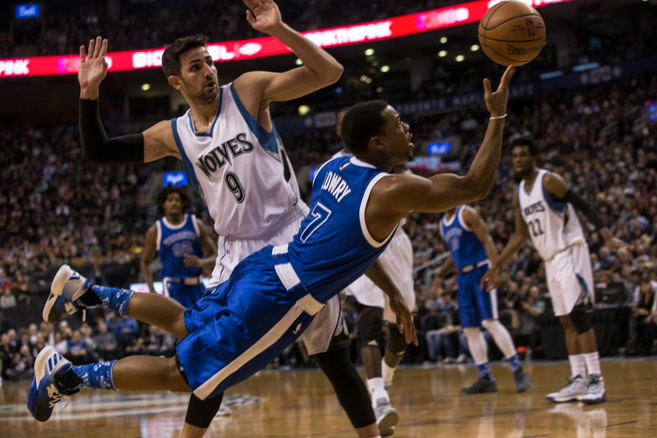 Toronto Raptors guard Kyle Lowry (7) makes a play in front of Minnesota Timberwolves guard Ricky Rubio (9) during the first half of an NBA basketball game in Toronto on Thursday, Dec. 8, 2016. (Chris Young/The Canadian Press via AP)