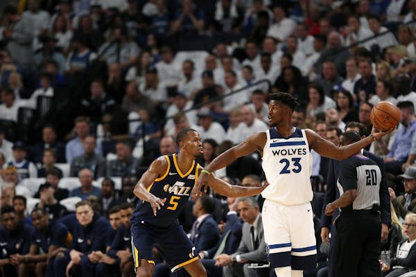 Minnesota Timberwolves forward Jimmy Butler (23) looked for an open teammate as Utah Jazz guard Rodney Hood (5) defended in the first half.