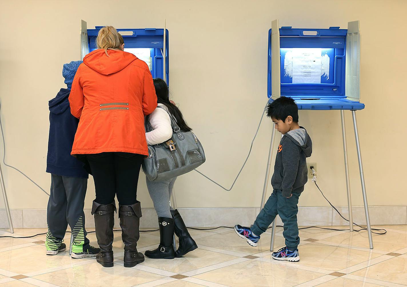 Karina Gutierrez, voted for the first time with her children Leonel Gutierrez, 8, left, Quetzal Cardoso, 6, center, and Carlos Cardoso, 6, at her side at St. George Antiochian Orthodox Church, Tuesday, November 8, 2016 in West St. Paul, MN. Gutierrez, who came to the United States when she was 16, said, "I feel like I finally belong to the American society and I feel like I was able to be a part of the American democracy."