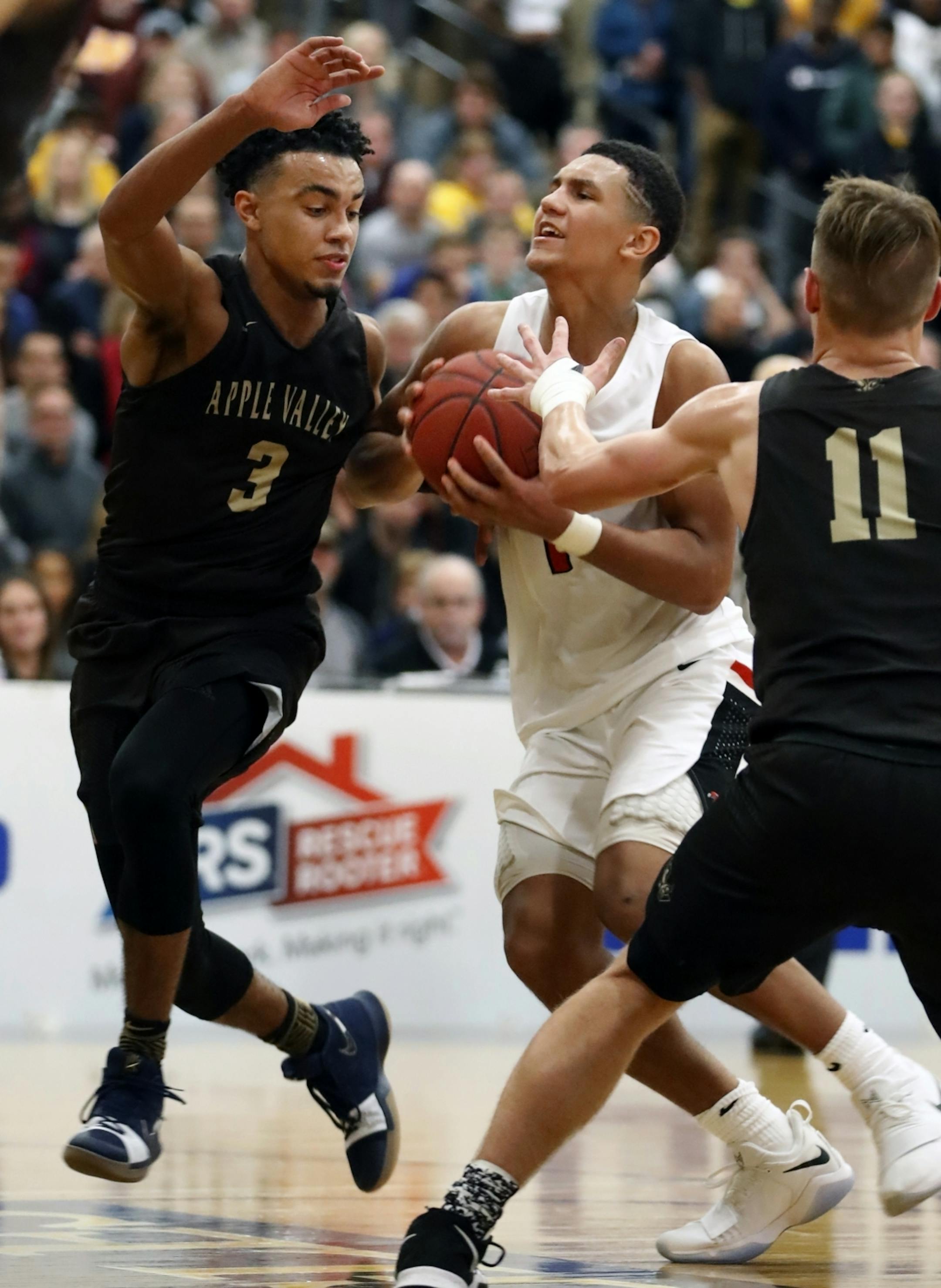 True Jones(3) defends against Jalen Suggs(1) of Minnehaha.