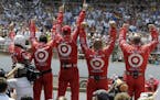 Crew members for Dario Franchitti, of Scotland, celebrate as he wins IndyCar's Indianapolis 500 auto race at Indianapolis Motor Speedway in Indianapol