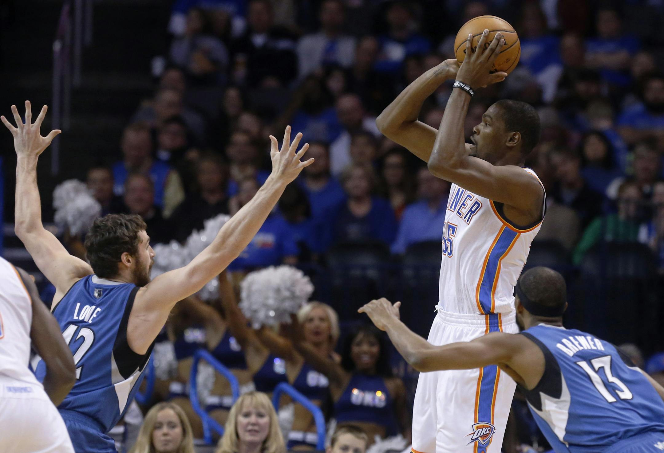 Oklahoma City Thunder forward Kevin Durant (35) shoots over Minnesota Timberwolves forward Kevin Love (42) and guard Alexey Shved (13) in the first quarter of an NBA basketball game in Oklahoma City, Sunday, Dec. 1, 2013. (AP Photo/Sue Ogrocki)