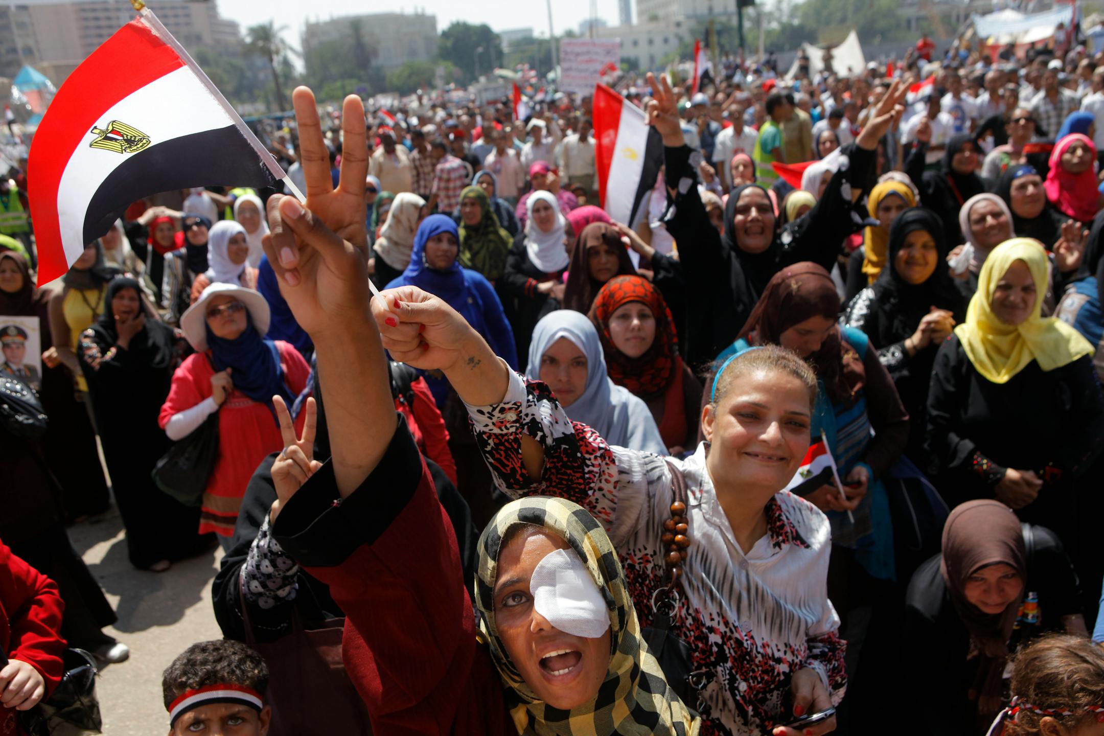 Zinab al-Saghier, an opponent of Egypt's ousted president Mohammed Morsi, who says she lost her eye during recent clashes with Morsi supporters, shouts anti-Muslim Brotherhood slogans during a protest in Tahrir Square, in Cairo, Egypt, Friday, July 5, 2013. Egypt's interim president held talks Saturday with the army chief and interior minister following an outburst of violence between supporters and opponents of ousted leader Mohammed Morsi that killed at least 36 people across the country and d