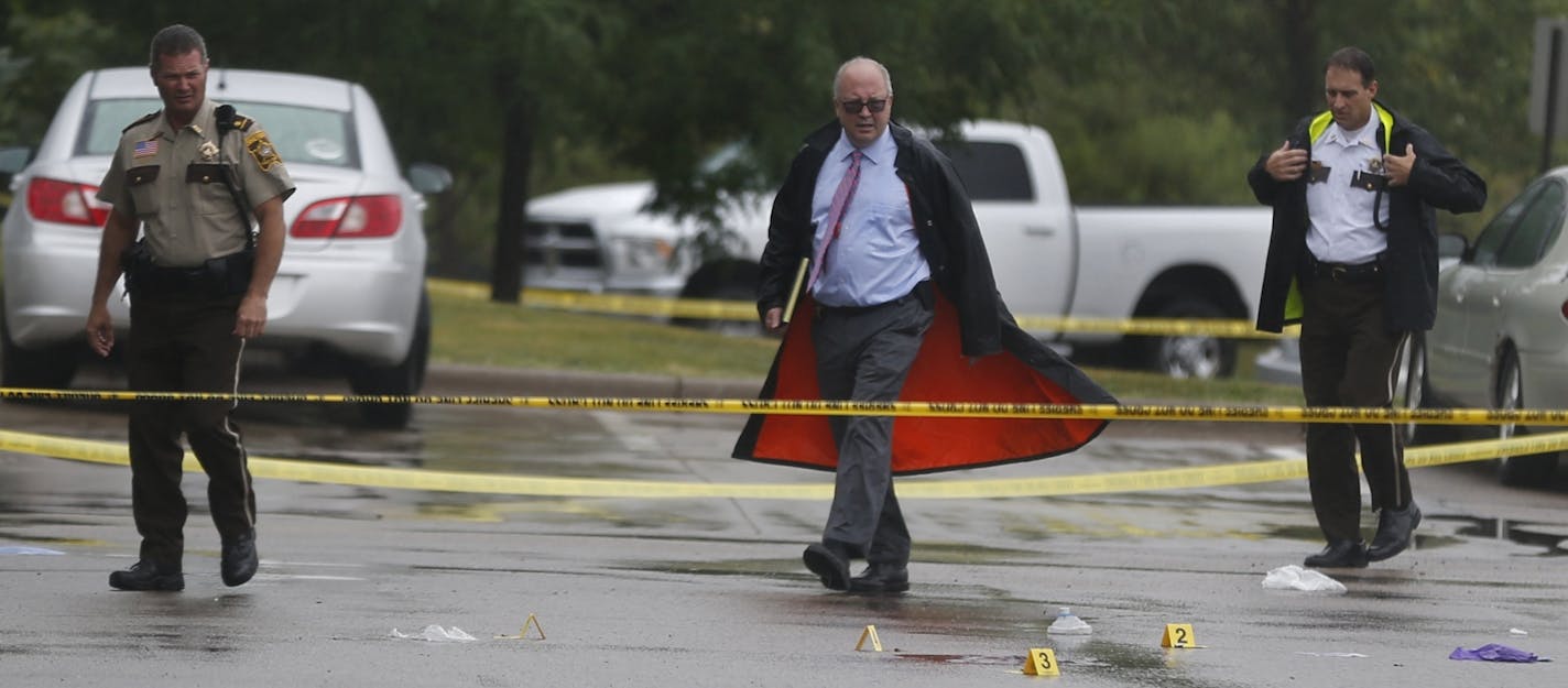 At the Holiday gas startion on Hwy. 96 near the the 35W exit in Arden Hills on Aug. 11, 2104, investigators examined the evidence at the site of a fatal shooting.