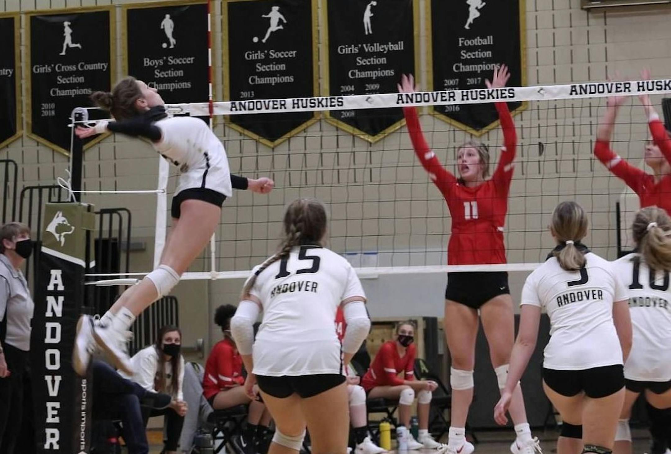 Andover sophomore Avery Bolles goes for a kill against Coon Rapids.