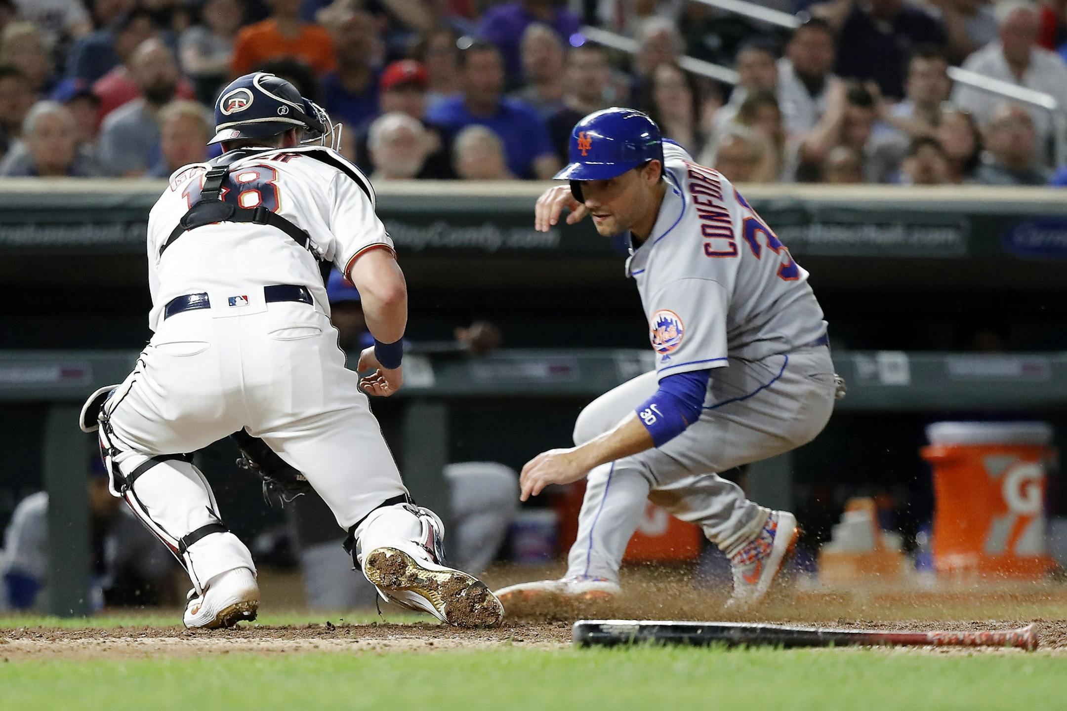 Minnesota Twins catcher Mitch Garver (18) tags out New York Mets right fielder Michael Conforto (30) in the eighth inning for a double play.