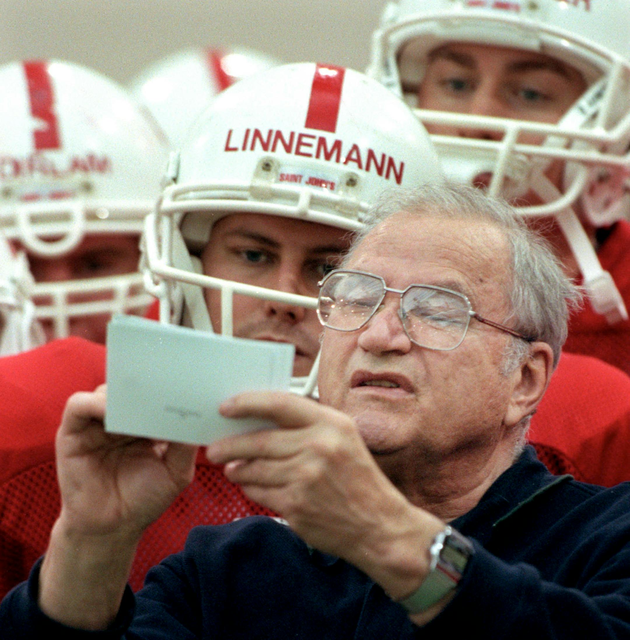 Coach John Gagliardi went over some of the plays with St. John's players at the start of a practice in November of 2000.