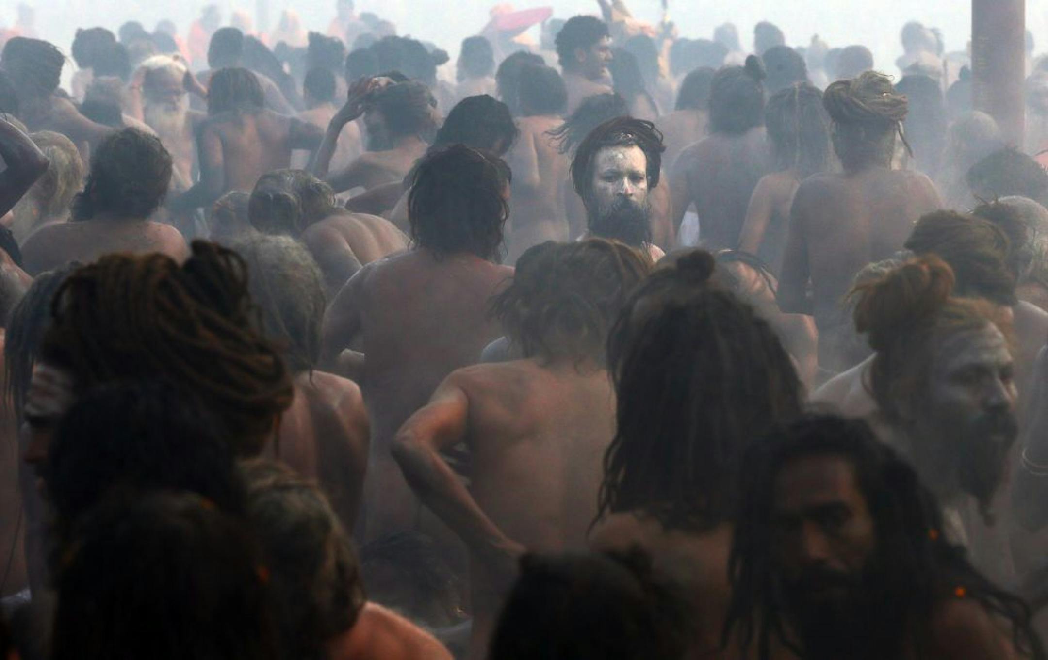 Naked Hindu holy men or a Naga Sadhus rub ash on their bodies after a dip at the confluence of the Rivers Ganges, Yamuna and mythical Saraswati. Millions of Hindu pilgrims are expected to take part in the large religious congregation, which falls every 12 years and lasts for a period of over a month, during which devotees wash themselves in the waters of the Ganges believing that it washes away their sins and ends the process of reincarnation.
