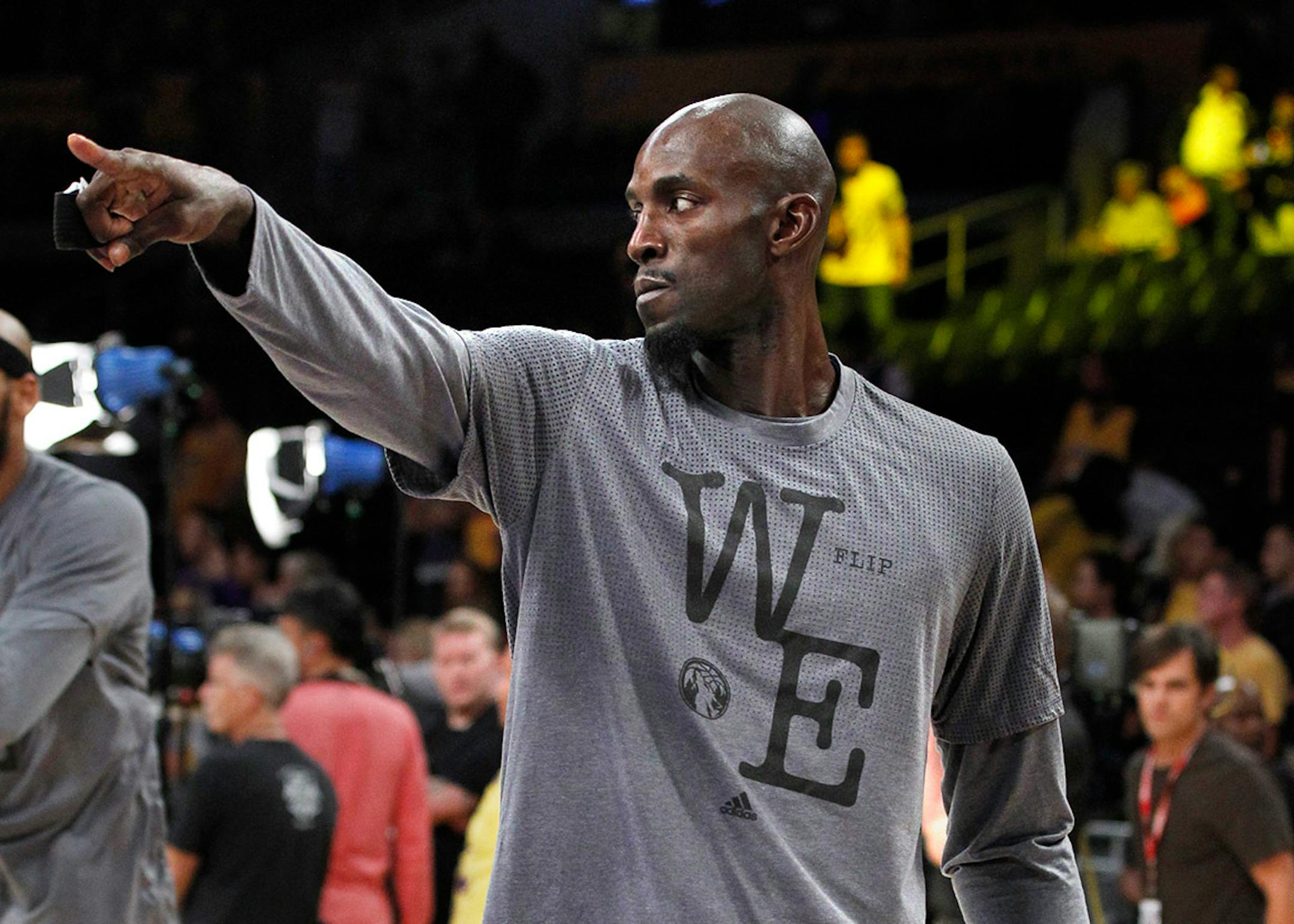 Minnesota Timberwolves forward Kevin Garnett points warms up before an NBA basketball game against the Los Angeles Lakers in Los Angeles, Wednesday, Oct. 28, 2015.