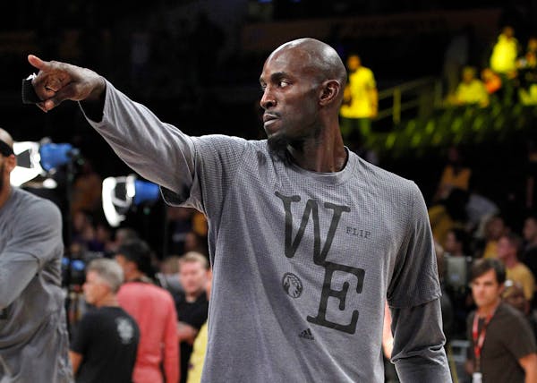 Minnesota Timberwolves forward Kevin Garnett points warms up before an NBA basketball game against the Los Angeles Lakers in Los Angeles, Wednesday, O