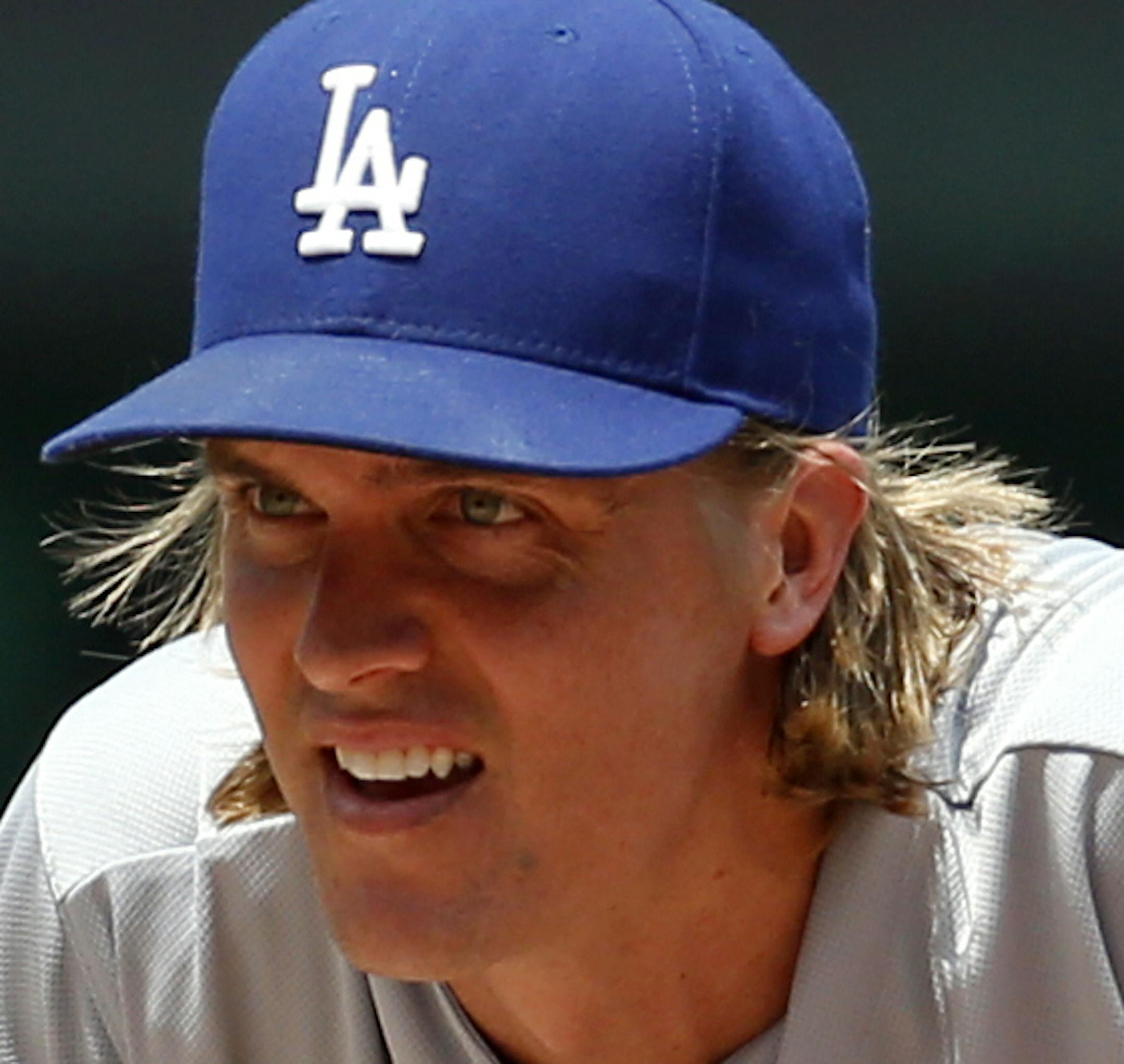 Los Angeles Dodgers starting pitcher Zack Greinke (21) pauses before throwing during the first inning of a baseball game against the Washington Nationals at Nationals Park, Sunday, July 19, 2015, in Washington. (AP Photo/Alex Brandon)